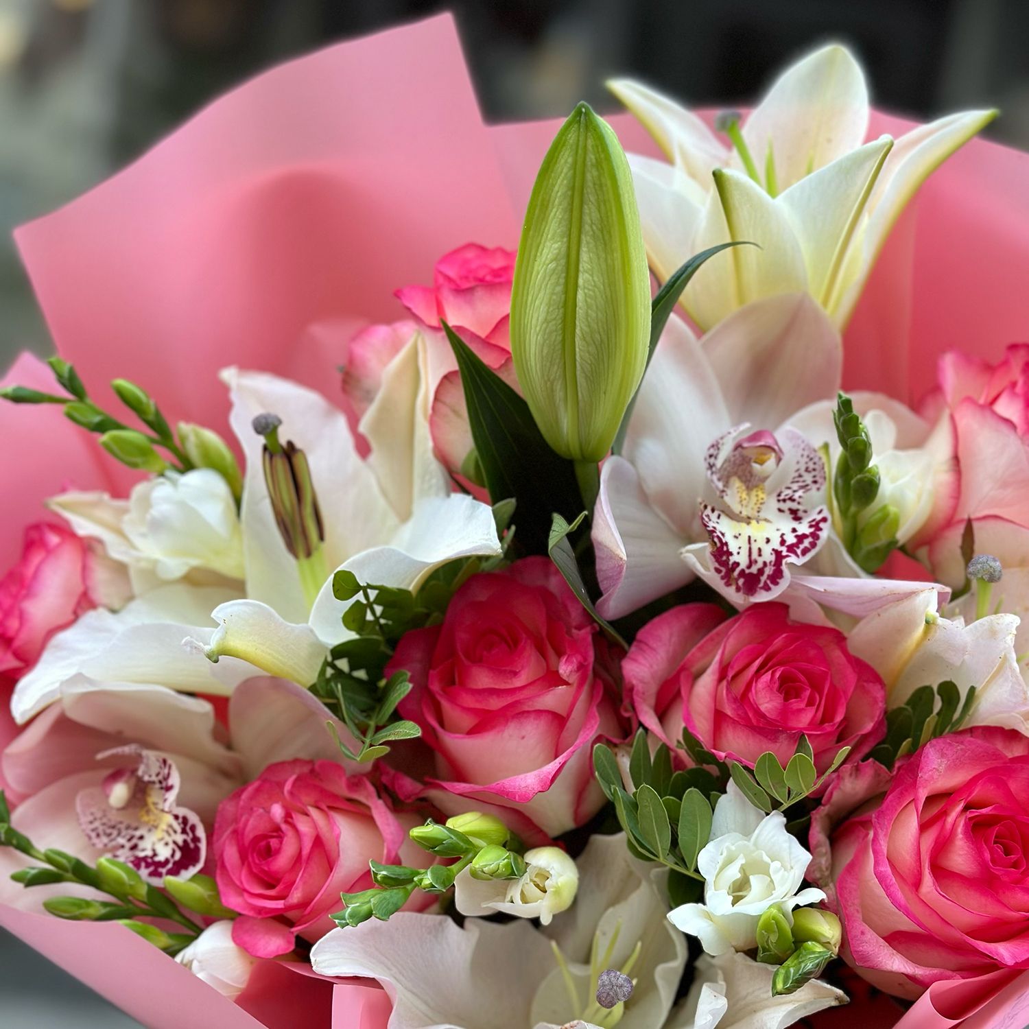 pink rose (7 pcs.), white lily, white freesia, white cymbidium, packaging, ribbon